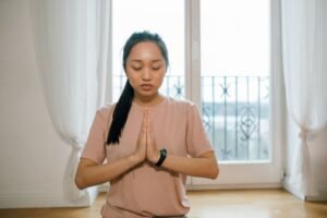 Femme les mains jointes, pratiquant un exercice de respiration calme